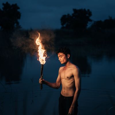 Silhouette of a person in a balancing pose against a dark background.